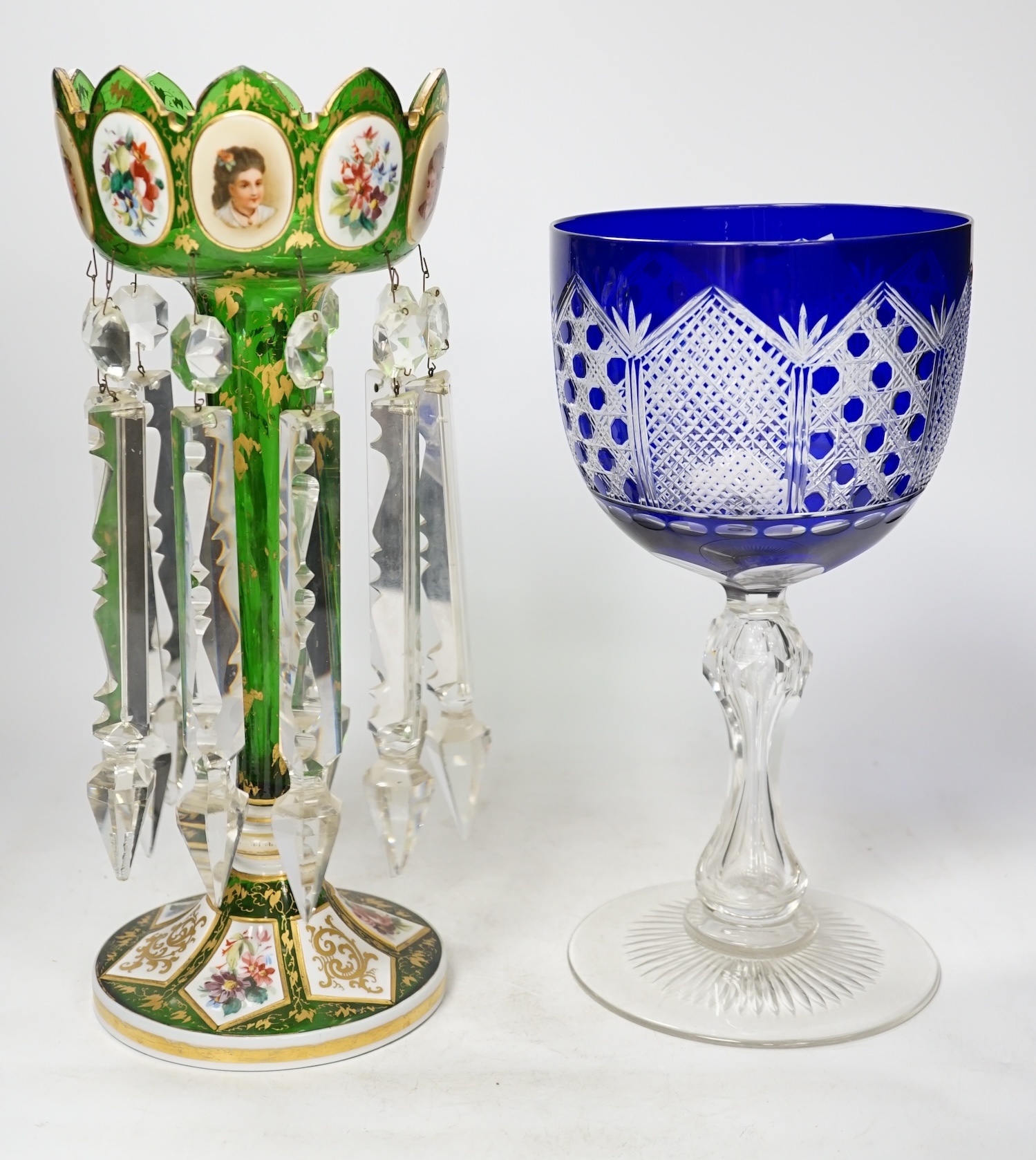 A 19th century Bohemian green glass overlaid cut glass lustre with drops together with an oversized goblet, largest 35cm high. Condition - goblet, good. Lustre, fair